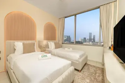a hotel room with two beds and a large window at Sky Gardens By Luxe Living Collection - Duplex 2BR - DIFC in Dubai