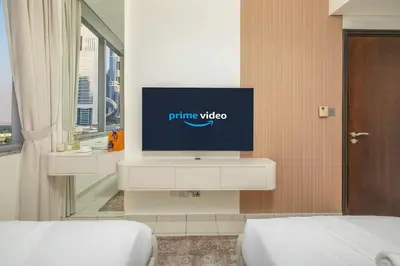 a tv sitting on a cabinet in a bedroom at Sky Gardens By Luxe Living Collection - Duplex 2BR - DIFC in Dubai