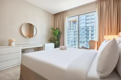 a white bedroom with a large bed and a window at STAY BY LATINEM Luxury 2BR Holiday Home G5- 5812 near Burj Khalifa in Dubai