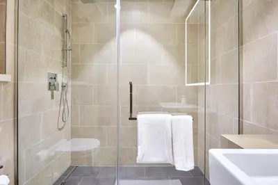 a bathroom with a shower with a glass door at STAY BY LATINEM Luxury 2BR Holiday Home G5- 5812 near Burj Khalifa in Dubai