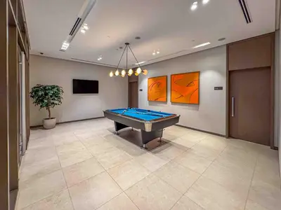 a large room with a pool table in it at Frank Porter - Grande Signature in Dubai
