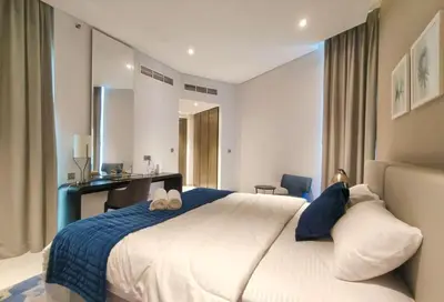 a bedroom with a large bed and a desk at Amazing Canal View 2 BR sweet retreat in Dubai