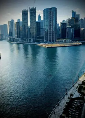 a large body of water with a city in the background at Amazing Canal View 2 BR sweet retreat in Dubai