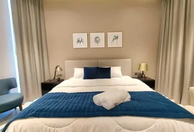 a bedroom with a blue and white bed with a towel on it at Amazing Canal View 2 BR sweet retreat in Dubai