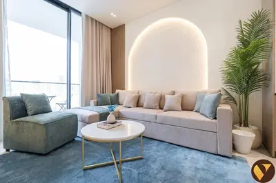a living room with a couch and a table at Vogue JVC Binghatti Phoenix near Circle Mall, One Bedroom Apartment with Balcony and Access to all Amenities in Dubai