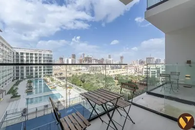 a balcony with chairs and a view of a city at Vogue JVC Binghatti Phoenix near Circle Mall, One Bedroom Apartment with Balcony and Access to all Amenities in Dubai