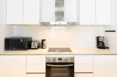a kitchen with a stove and a microwave at Stylish 1BR Stay in City Walk Building 10 in Dubai