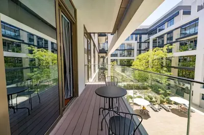a balcony with tables and chairs on a building at Stylish 1BR Stay in City Walk Building 10 in Dubai