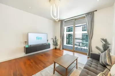 a living room with a couch and a flat screen tv at Stylish 1BR Stay in City Walk Building 10 in Dubai