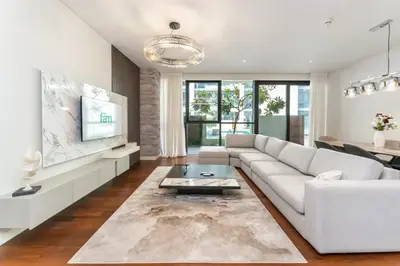 a living room with a white couch and a table at Elegant 2BR with Maids Room City Walk in Dubai