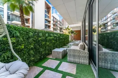an outdoor patio with chairs and plants on a building at Elegant 2BR with Maids Room City Walk in Dubai