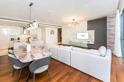 a living room with a table and a white couch at Elegant 2BR with Maids Room City Walk in Dubai