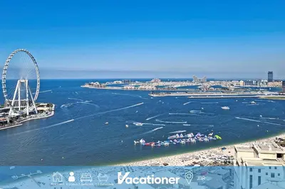 a group of people in boats in the water at Vacationer l Cozy 2 Bed l Breathtaking Sea and Ain Dubai Views in Dubai