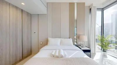 a bedroom with a bed with two towels on it at Vacationer l Chic Upgraded Studio l City Views l Dubai Marina in Dubai
