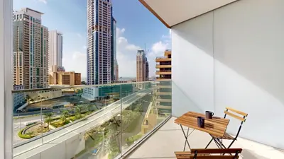 a bench on a balcony with a view of a city at Vacationer l Chic Upgraded Studio l City Views l Dubai Marina in Dubai
