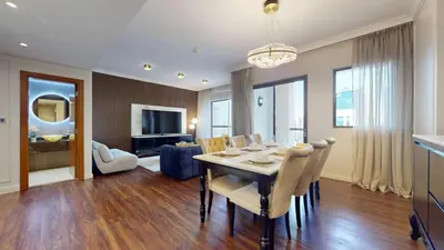 a dining room and living room with a table and chairs at Vacationer l Mesmerizing 2 Bed l Sea and Ain Dubai View l JBR in Dubai