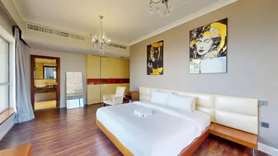 a bedroom with a large white bed in a room at Vacationer l Mesmerizing 2 Bed l Sea and Ain Dubai View l JBR in Dubai
