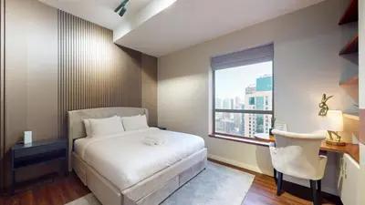 a bedroom with a bed and a desk and a window at Vacationer l Mesmerizing 2 Bed l Sea and Ain Dubai View l JBR in Dubai