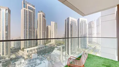 a balcony with a view of a city with tall buildings at Vacationer l 1 Bedroom in Creek Harbour l Skyline Views in Dubai