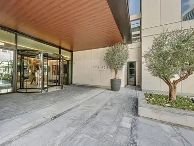 a building with two trees in front of it at Vacationer l 1 Bedroom in Creek Harbour l Skyline Views in Dubai