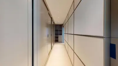 a hallway with white walls and glass doors at Vacationer l Premium 2 Bedroom l Business Bay l Prime Location in Dubai