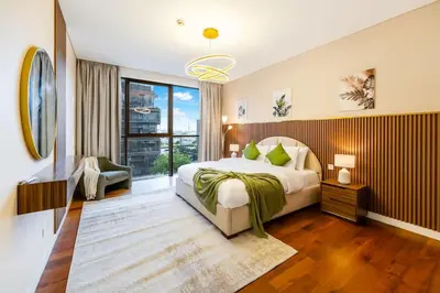 a bedroom with a large bed and a large window at Elegant 3BR with Maids Room City Walk Dubai in Dubai
