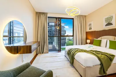a bedroom with a bed and a desk and a window at Elegant 3BR with Maids Room City Walk Dubai in Dubai