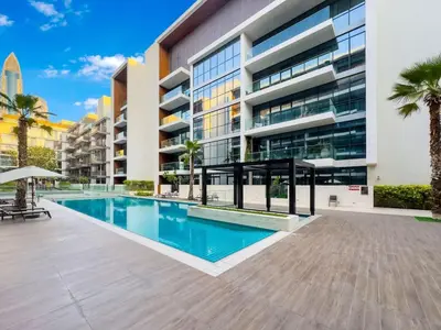 a swimming pool in front of a building at Elegant 3BR with Maids Room City Walk Dubai in Dubai