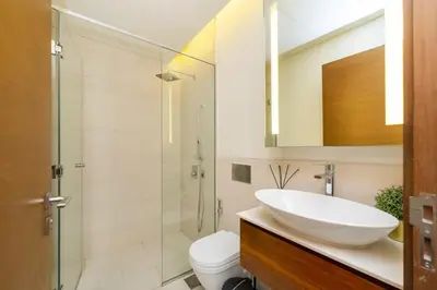 a bathroom with a sink and a toilet and a shower at Stylish 2BR with Maids Room City Walk in Dubai