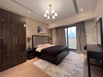 a bedroom with a large bed and a large window at Elite Residence 1, Downtown Dubai in Dubai