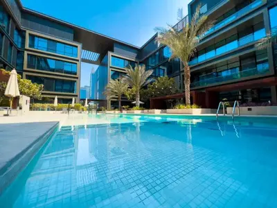 a large swimming pool in front of a building at Spacious 2BR with Maids Room City Walk in Dubai