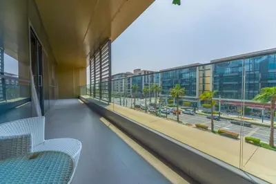 a balcony with chairs and a view of a street at Spacious 2BR with Maids Room City Walk in Dubai
