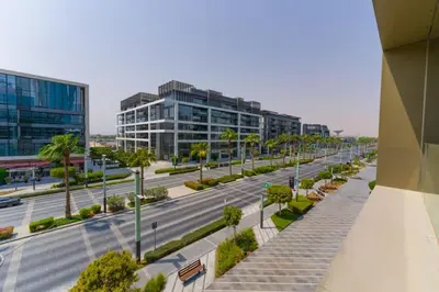 an empty street in a city with tall buildings at Spacious 2BR with Maids Room City Walk in Dubai