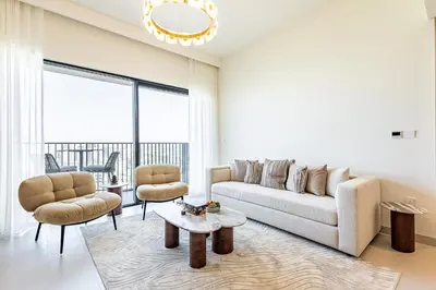 a living room with a couch and two chairs and a table at Superhost - 1BR Apartment, Balcony, Pool & Gym , Dubai Hills in Dubai