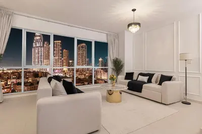 a living room with a view of a city skyline at Large 4 Bed Apt with Burj View and 8 Min Walk to Mall by Vista Stays DXB in Dubai