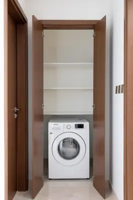 a laundry room with a washer and dryer at Luxury & Modern Unit in Emaar Beachfront in Dubai