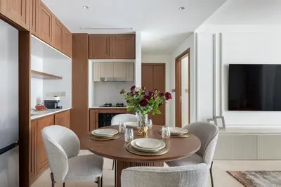 a dining room table with chairs and a vase of flowers at Luxury & Modern Unit in Emaar Beachfront in Dubai