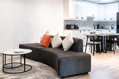 a living room with a couch and a kitchen at Sulafa Tower, Dubai Marina - Onelink in Dubai