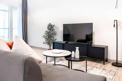 a living room with a couch and a tv at Sulafa Tower, Dubai Marina - Onelink in Dubai
