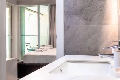 a bathroom with a tub and a bedroom with a bed at Sulafa Tower, Dubai Marina - Onelink in Dubai