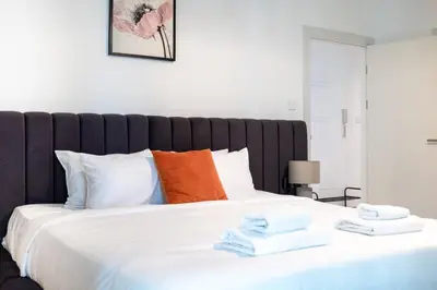 a bedroom with a large white bed with towels on it at Sulafa Tower, Dubai Marina - Onelink in Dubai
