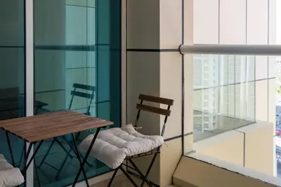 a balcony with a table and chairs on a building at Sulafa Tower, Dubai Marina - Onelink in Dubai
