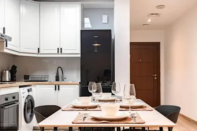 a kitchen with a table with wine glasses on it at Sulafa Tower, Dubai Marina - Onelink in Dubai