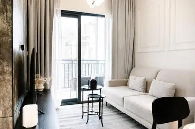 a living room with a white couch and a window at Zada Tower, Business Bay - Onelink in Dubai