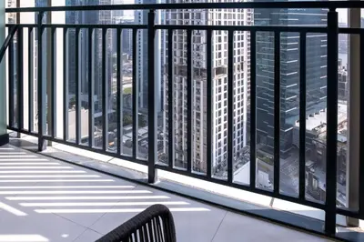 a bench on a balcony with a view of a city at Zada Tower, Business Bay - Onelink in Dubai