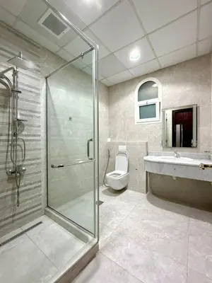 a bathroom with a shower and a toilet and a sink at Risephoenix Japanese Luxury Capsule Villa - Dubai in Dubai