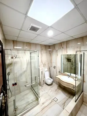 a bathroom with a shower and a toilet and a sink at Risephoenix Japanese Luxury Capsule Villa - Dubai in Dubai