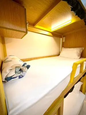 an empty bunk bed in a small room at Risephoenix Japanese Luxury Capsule Villa - Dubai in Dubai