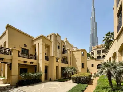 a large building with a tower in the background at Silkhaus in Al Tajer in Souk al Bahar Direct Access in Dubai