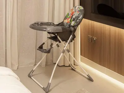 a black high chair sitting in a room at Peninsula One Suites by Prestige Nest in Dubai
